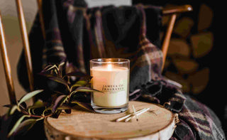 A James and Co Fragrance candle that has been properly cared for, sitting on a wooden stool