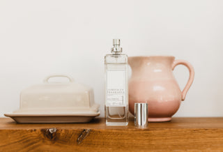 No.1 White Room Spay on a wooden shelf in front of a blush pink jug and a neutral butter dish