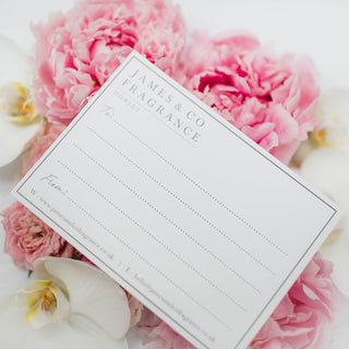 An image of a James & Co Gift card sitting on some flowers.