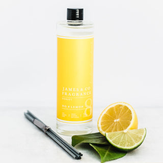 Our No. 8 Lemon 200ml diffuser refill sat with lemon wedges and bergamot leaves