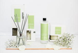 Various pieces of the no.11 collection including a diffuser oil, a candle and a reed diffuser.