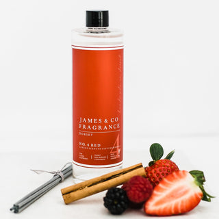 Our No. 4 Red 200ml diffuser refill, next to wild strawberries, raspberries, blackberries, and a cinnamon stick