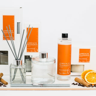 Various items from our No.6 orange collections, including a refill oil, a reed diffuser and a candle.