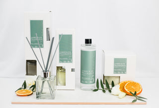 The No.5 Green collection sitting against a white background. Various items are in the picture, including a refill oil, a candle and a reed diffuser with grey reeds.