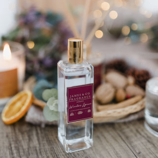 A close-up photo with a festive feel of the luxury James and Co fragrance room spray in winter spice.