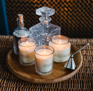 Candle and decanter set on a woven surface