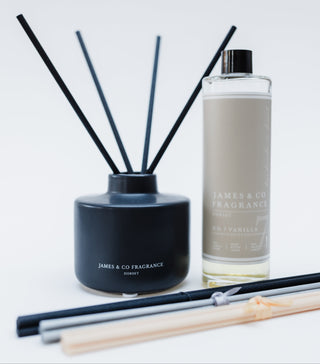 Reed diffuser set with black container and bottle labeled 'James & Co Fragrance' on a light gray background.