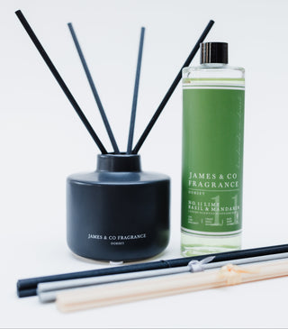 Reed diffuser set with black container and green bottle labeled 'James & Co Fragrance' on a white background.