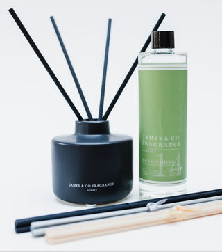 Reed diffuser set with black container and green bottle labeled 'James & Co Fragrance' on a white background.
