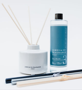 Reed diffuser and bottle of James & Co Fragrance on a white background
