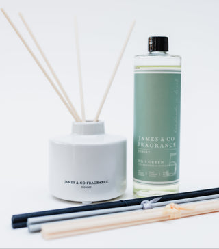 Reed diffuser set with bottle and sticks on a white background