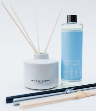 Reed diffuser set with bottle and sticks on a white background