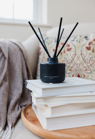 Black diffuser on a stack of books with a blurred background