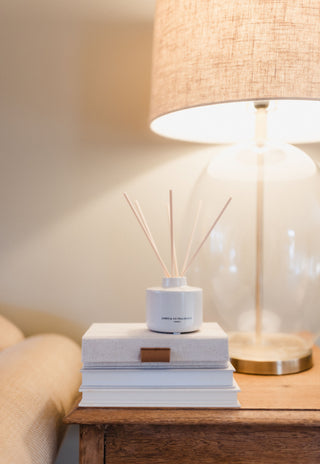 Diffuser on books with a lamp in the background