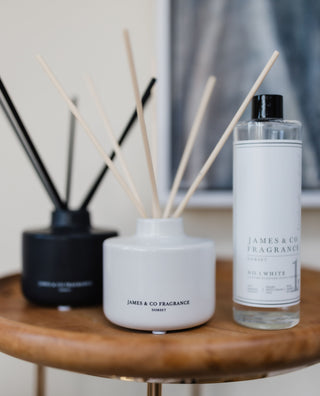 Jame & Co Fragrance diffuser and bottle on a wooden table