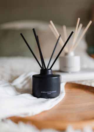 Black diffuser with wooden sticks on a surface
