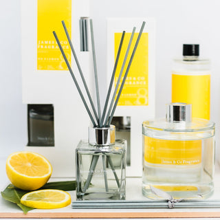 Our No. 8 Lemon 100ml reed diffuser sat with lemon wedges and bergamot leaves