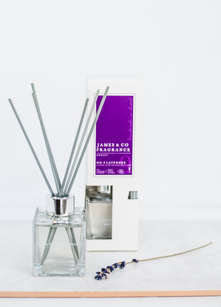 Our No. 9 Lavender 100ml reed diffuser sat with a sprig of fresh lavender