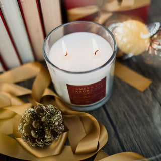 Luxury Winter spice 2-wick candle against a festive wintery background.